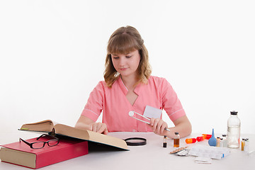 Image showing Thoughtful doctor read the description pills