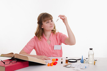 Image showing Pharmacist considers powder in a test tube