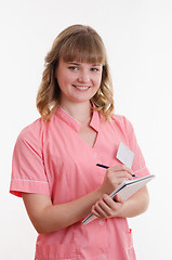 Image showing Doctor writing in a notebook