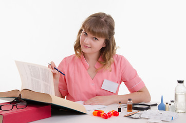 Image showing Pharmacist enjoy reading medication guide