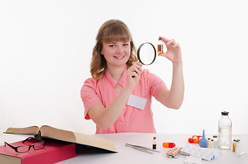 Image showing Pharmacist considers liquid medicine