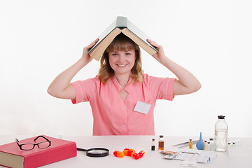 Image showing Pharmacist with reference drugs on the head