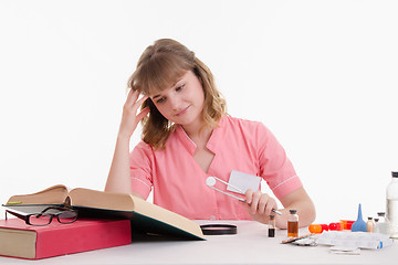 Image showing Student Pharmacist looking in the directory description tablets