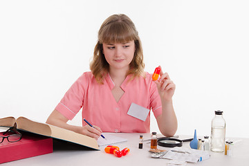 Image showing Pharmacist studying composition pills