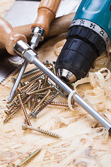 Image showing Drill with timber, screwdrivers and screws