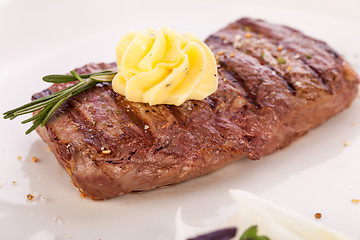 Image showing Grilled beef steak topped with butter and rosemary