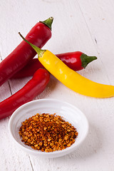 Image showing Fresh red and yellow chili peppers with spice