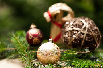 Image showing Gold Christmas ornament on leaves