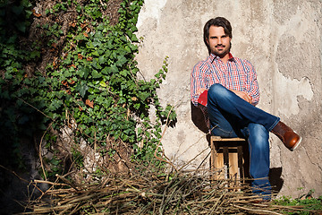 Image showing Male model sitting with legs crossed