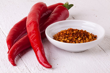 Image showing Fresh red and yellow chili peppers with spice