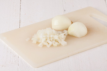 Image showing Whole, peeled and diced brown onion