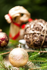 Image showing Gold Christmas ornament on leaves