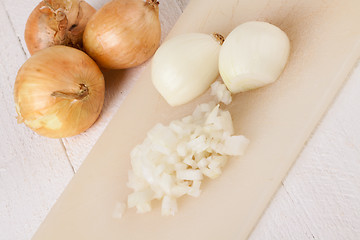 Image showing Whole, peeled and diced brown onion