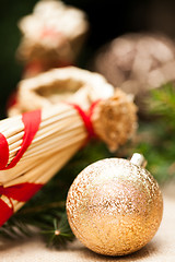 Image showing Gold Christmas ornament on leaves
