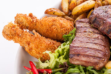 Image showing Platter of mixed meats, salad and French fries