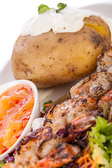 Image showing Grilled prawns with endive salad and jacket potato