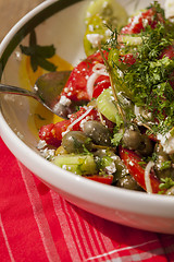 Image showing Bowl of Marinated Greek Salad with Red Napkin