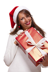 Image showing Pretty woman in a Santa hat with a large gift