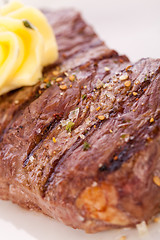 Image showing Grilled beef steak topped with butter and rosemary