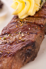 Image showing Grilled beef steak topped with butter and rosemary