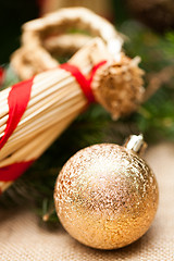 Image showing Gold Christmas ornament on leaves