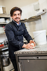 Image showing Chef tossing dough while making pastries