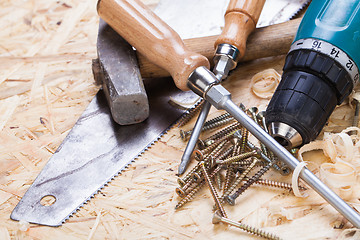 Image showing Drill with timber, screwdrivers and screws