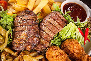 Image showing Platter of mixed meats, salad and French fries