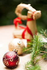 Image showing Gold Christmas ornament on leaves