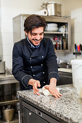 Image showing Chef tossing dough while making pastries