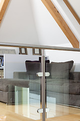 Image showing Grey Sofa Behind Metal and Glass Railing