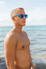 Image showing Man in blue swim shorts in the beach