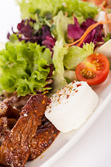 Image showing grilled beef stripes fresh salad and goat cheese