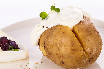 Image showing Baked jacket potato with sour cream sauce