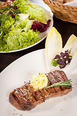 Image showing Grilled beef steak topped with butter and rosemary