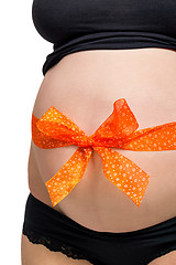 Image showing Pregnant woman wearing a bow on her belly