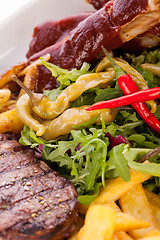 Image showing Platter of mixed meats, salad and French fries