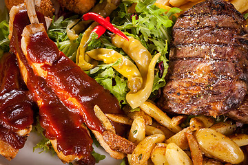 Image showing Platter of mixed meats, salad and French fries