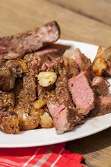 Image showing Plate of Grilled Steak and Garlic with Red Napkin