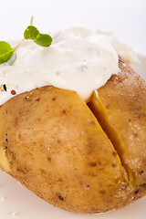 Image showing Baked jacket potato with sour cream sauce