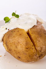 Image showing Baked jacket potato with sour cream sauce