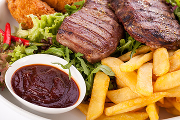 Image showing Platter of mixed meats, salad and French fries