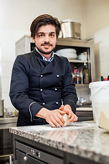 Image showing Chef tossing dough while making pastries