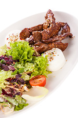 Image showing grilled beef stripes fresh salad and goat cheese