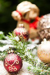 Image showing Gold Christmas ornament on leaves