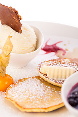 Image showing tasty sweet pancakes with vanilla icecream and topping