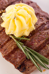 Image showing Grilled beef steak topped with butter and rosemary