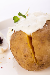 Image showing Baked jacket potato with sour cream sauce