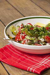 Image showing Bowl of Marinated Greek Salad with Red Napkin