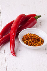 Image showing Fresh red and yellow chili peppers with spice